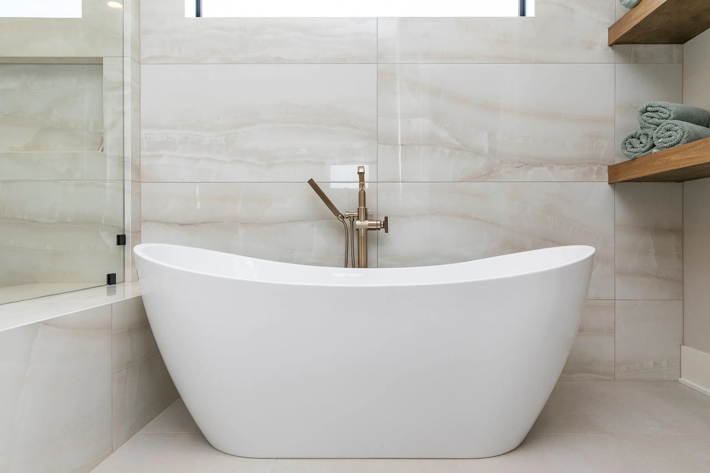 Freestanding tub with marble surround by MIR Homes